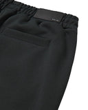 DRIPNORD Amiri black track pants with elastic waistband and leather logo patch.