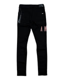DRIPNORD black Amiri core logo jeans with pink embroidered lettering on the back pocket and ribbed detailing at the ankle.