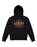 DRIPNORD black cotton hoodie with white AMIRI logo and red snake graphic. Features a hood, front pocket, and long sleeves.