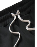 DRIPNORD black Amiri track pants with white drawstring and silver hardware detail.