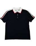 DRIPNORD black cotton Gucci polo shirt with white collar, red trim, and signature green and red stripe detail on sleeves.