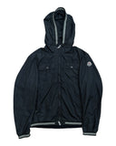DRIPNORD black Moncler windbreaker jacket with hood, two chest pockets, and striped trim on cuffs and hem.