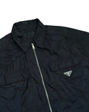 DRIPNORD black Re-Nylon Prada shirt with zip closure, two chest pockets, and iconic triangular logo.