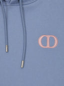 DRIPNORD blue cotton hoodie with pink embroidered CD icon logo on chest and silver-tipped drawstrings.