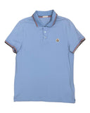DRIPNORD light blue cotton Moncler polo shirt with striped collar and cuffs, featuring a chest logo.