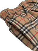 DRIPNORD beige Burberry monogram print swim shorts with elastic waistband and drawstring.