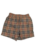 DRIPNORD Burberry monogram swim shorts in beige, black, red, and white plaid pattern. Elastic waistband.