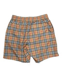 DRIPNORD Burberry Monogram Swim Shorts in tan, black, red, and white plaid pattern. Elastic waistband and side pockets.