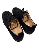 DRIPNORD Christian Louboutin Junior Spikes black suede low-top sneakers with signature spikes and red sole detail.