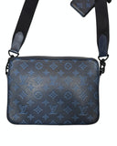 DRIPNORD Louis Vuitton Shadow Duo Messenger bag in navy blue embossed leather with adjustable strap.