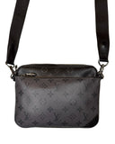 DRIPNORD Louis Vuitton Trio Messenger bag in Monogram Eclipse canvas with adjustable strap and silver hardware.