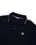 DRIPNORD black Moncler polo shirt with red, white, and blue striped collar and embroidered logo.