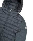 DRIPNORD Moncler dark grey hooded puffer cardigan with quilted front and knit sleeves. Features a full zip closure and Moncler logo patch on left sleeve.