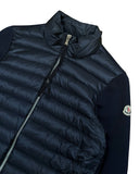 DRIPNORD navy blue Moncler women's puffer cardigan with quilted front and contrast sleeves. Features a stand-up collar and zip closure.