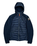 DRIPNORD navy blue hybrid puffer jacket with quilted front, fleece sleeves, and hood. Features orange zipper pull and logo patch.