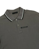 DRIPNORD Prada grey cotton polo shirt with black and white striped collar and chest logo.
