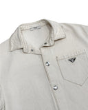 DRIPNORD Prada off-white cotton blend shirt with silver snap buttons and chest pocket featuring the iconic Prada triangle logo.