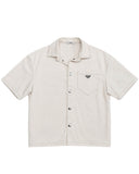 DRIPNORD Prada off-white short-sleeve button-up shirt with chest pocket and silver snap buttons.