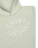DRIPNORD light sage green cotton oversized hoodie with AMIRI Arts District graphic print on chest. Features a drawstring hood and front pocket.