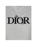 DRIPNORD white cotton t-shirt with black embroidered DIOR logo and a safety pin detail.